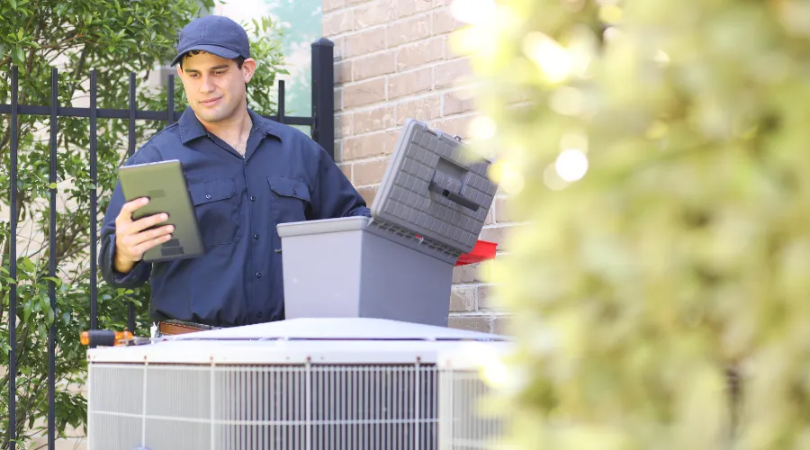 Hvac Tech Looking At Tablet