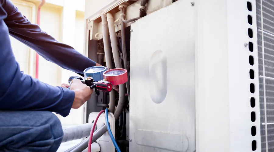 Hvac Tech Performing Maintenance On Commercial Unit