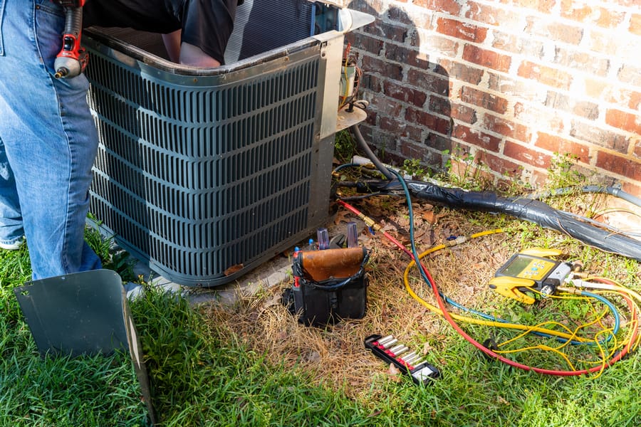 An AC unit open and being repaired