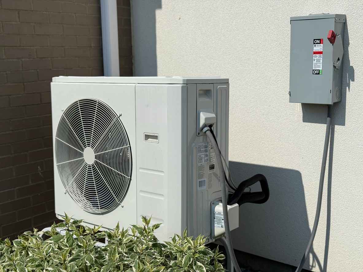 Modern heat pump system on the side of a house